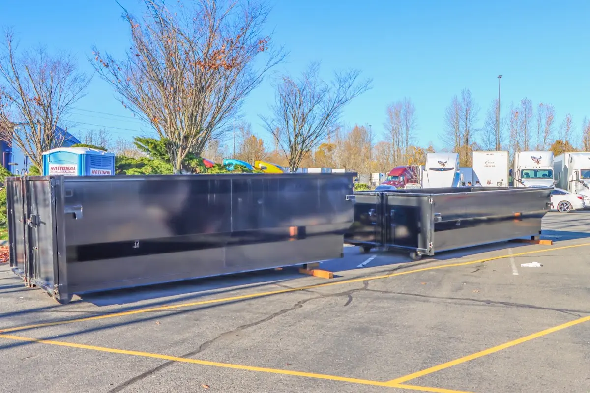 Professional dumpster rental service with roll-off container on residential driveway in Cleveland Heights